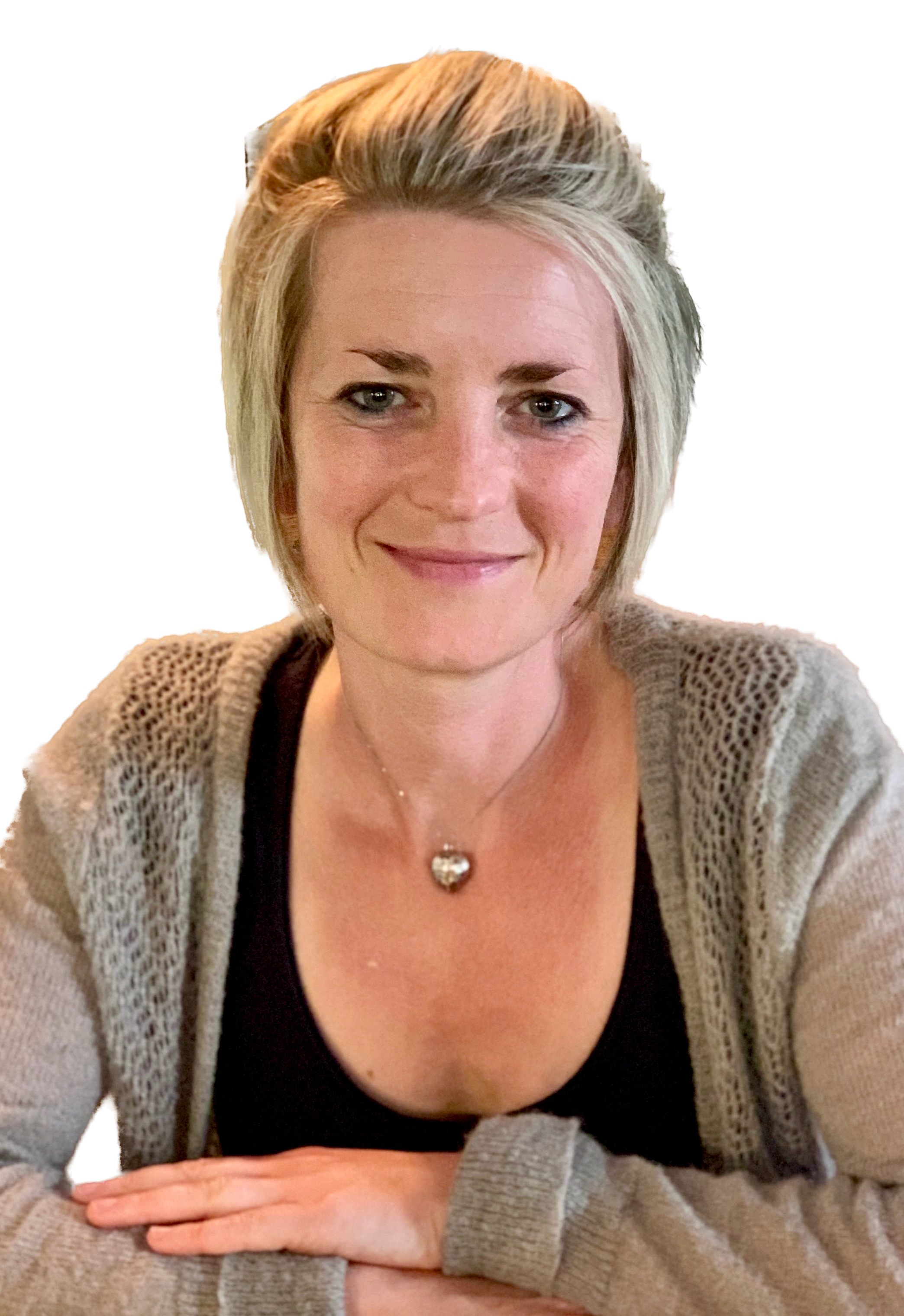 Dr Ruth sitting in front of wooden wall with flowers in foreground